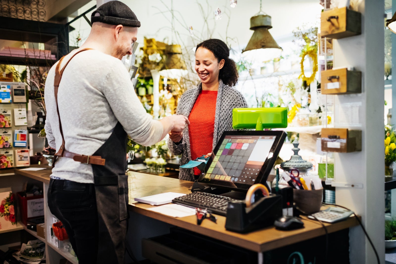 Florist Serving Customer At Cash Register